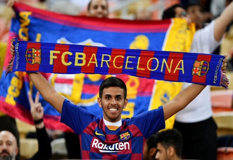 Discover the Deeper Meaning Behind — What Does Força Barça Mean Fans waving “Força Barça” flags at Camp Nou showing their pride
