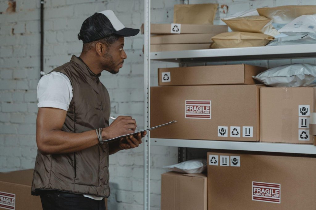 Fine Art Logistics in Canada: Inside the Trade's Quiet Momentum Warehouse worker checking fragile crates, a key step in fine art logistics in Canada.